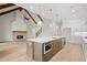 Spacious kitchen features an island with stainless steel appliances and a cozy brick fireplace at 3819 Havenrock Dr, Marietta, GA 30066