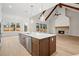 Open kitchen with white countertops, an island with stainless steel appliances, and a brick fireplace at 3819 Havenrock Dr, Marietta, GA 30066