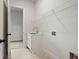 Bright laundry room with utility sink, modern faucet, and storage shelves at 3819 Havenrock Dr, Marietta, GA 30066