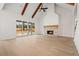 Spacious living room featuring vaulted ceilings, hardwood floors, large sliding doors, and a brick fireplace at 3819 Havenrock Dr, Marietta, GA 30066