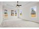 Spacious main bedroom featuring tray ceiling, carpet floors, ceiling fan, and natural light at 3819 Havenrock Dr, Marietta, GA 30066