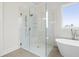 Bright bathroom featuring a glass enclosed walk-in shower and modern soaking tub with tile surround at 3819 Havenrock Dr, Marietta, GA 30066