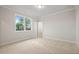Empty bedroom with fresh carpet, large windows, and a walk-in closet at 3820 Havenrock Dr, Marietta, GA 30066