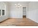 Bright dining room featuring wainscoting, a modern chandelier, and hardwood flooring at 3820 Havenrock Dr, Marietta, GA 30066