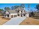 Stunning two-story brick home with a three-car garage and a spacious concrete driveway at 3820 Havenrock Dr, Marietta, GA 30066