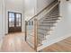Elegant foyer featuring hardwood floors, a staircase with iron balusters, and a double door at 3820 Havenrock Dr, Marietta, GA 30066