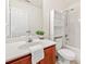 Bathroom featuring a vanity, toilet, and shower with coordinated white storage unit at 5965 Ellington Cv, Cumming, GA 30040