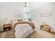 Bright bedroom with a ceiling fan, decorative pillows, and a cozy throw blanket on the bed at 5965 Ellington Cv, Cumming, GA 30040