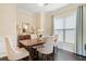 Elegant dining room with dark hardwood floors and a dining table with seating at 5965 Ellington Cv, Cumming, GA 30040