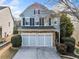 Charming two-story home featuring a stone-accented facade and attached two-car garage at 5965 Ellington Cv, Cumming, GA 30040