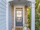 Welcoming front door with sidelights, complemented by stone accents and landscaping at 5965 Ellington Cv, Cumming, GA 30040