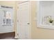 Bright hallway with a decorative shelf with decorative niche and a door to the outside at 5965 Ellington Cv, Cumming, GA 30040