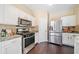 Bright kitchen with stainless steel appliances, granite countertops, and white cabinetry at 5965 Ellington Cv, Cumming, GA 30040