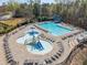 Large community pool area with a separate kiddie pool and ample lounge chairs at 5965 Ellington Cv, Cumming, GA 30040