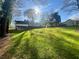 Expansive backyard with lush green lawn leading up to the rear of the home at 4651 S Roberts Drive, Sugar Hill, GA 30518