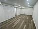 Finished basement with modern flooring and recessed lighting at 4651 S Roberts Drive, Sugar Hill, GA 30518