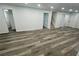Finished basement with modern flooring, recessed lighting and access to the stairs at 4651 S Roberts Drive, Sugar Hill, GA 30518