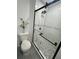 Bathroom with a modern glass enclosed shower and a mosaic tiled shower floor at 4651 S Roberts Drive, Sugar Hill, GA 30518