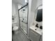 Updated bathroom features a modern glass enclosed shower, and a decorative vanity at 4651 S Roberts Drive, Sugar Hill, GA 30518