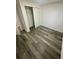 Bedroom with gray wood flooring, neutral walls, and closet space at 4651 S Roberts Drive, Sugar Hill, GA 30518
