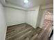 Bedroom with gray wood flooring, neutral walls, and closet with sliding doors at 4651 S Roberts Drive, Sugar Hill, GA 30518