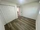 Bedroom with gray wood flooring, neutral walls, and closet with sliding doors at 4651 S Roberts Drive, Sugar Hill, GA 30518