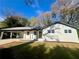 Charming single-story home with a white brick exterior and a covered carport at 4651 S Roberts Drive, Sugar Hill, GA 30518