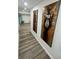Hallway featuring gray wood flooring, neutral walls with artwork, and recessed lighting at 4651 S Roberts Drive, Sugar Hill, GA 30518