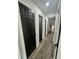 Hallway with modern flooring, recessed lighting, and dark paneled doors at 4651 S Roberts Drive, Sugar Hill, GA 30518