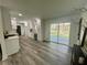 Open kitchen with white cabinets, new appliances, and access to outdoor deck at 4651 S Roberts Drive, Sugar Hill, GA 30518