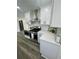 Modern kitchen features stainless steel appliances, white cabinetry, and stone countertops at 4651 S Roberts Drive, Sugar Hill, GA 30518