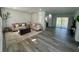 Spacious living area with wood floors, neutral furniture, and an open layout to the kitchen at 4651 S Roberts Drive, Sugar Hill, GA 30518