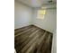 Small room featuring a window, gray wood flooring, and neutral walls at 4651 S Roberts Drive, Sugar Hill, GA 30518