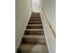 Carpeted staircase with wooden railing at 4651 S Roberts Drive, Sugar Hill, GA 30518