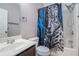 Bathroom with blue printed shower curtain, sink and natural light at 508 Arbor Trl, Loganville, GA 30052