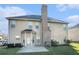 Back exterior view of the home with a brick chimney and a small patio at 508 Arbor Trl, Loganville, GA 30052