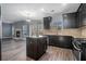 Modern kitchen with dark wood cabinets, granite counters, and island with seating at 508 Arbor Trl, Loganville, GA 30052