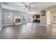 Open-concept living room features hardwood floors, a fireplace, and natural light at 508 Arbor Trl, Loganville, GA 30052
