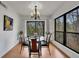 Bright dining room with a round table, modern chandelier, and large windows at 810 Lismore Se # 10, Smyrna, GA 30080