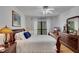 Cozy main bedroom featuring a wooden bed frame, ample natural light, and dark wood furniture at 810 Lismore Se # 10, Smyrna, GA 30080