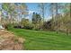 The backyard features a lush green lawn with trees and landscaping at 1870 Abercorn Way, Snellville, GA 30078
