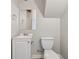 Small bathroom featuring a toilet, sink, cabinet, and mirror at 1870 Abercorn Way, Snellville, GA 30078