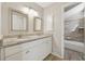 Bathroom featuring double sinks with granite counters and a tile shower/tub combo at 1870 Abercorn Way, Snellville, GA 30078
