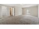 Large, carpeted bedroom featuring three doorways and a window at 1870 Abercorn Way, Snellville, GA 30078