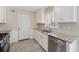 Updated kitchen with stainless steel appliances, white cabinets, and granite countertops at 1870 Abercorn Way, Snellville, GA 30078