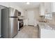 Modern kitchen featuring stainless steel appliances, granite countertops, and ample cabinet space at 1870 Abercorn Way, Snellville, GA 30078
