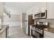 Modern kitchen with stainless steel appliances and granite countertops and tile flooring at 1870 Abercorn Way, Snellville, GA 30078