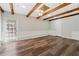 Versatile living area with exposed wood beams, white wainscoting, and outdoor access at 1870 Abercorn Way, Snellville, GA 30078
