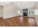 Bright living room with a stone fireplace, hardwood floors, and two windows for natural light at 1870 Abercorn Way, Snellville, GA 30078
