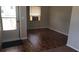 Cozy living space with a dark wood floor, window AC unit, and a view into another room at 2213 Sharon Way, Decatur, GA 30032